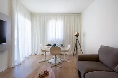 a living room with a table and a couch at Stylish Central Apartment • City Views • Prime Location • Parking in Nicosia