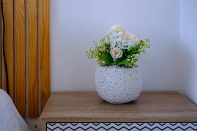 a vase filled with flowers sitting on a table at Endless Summer Beach House in Pervolia