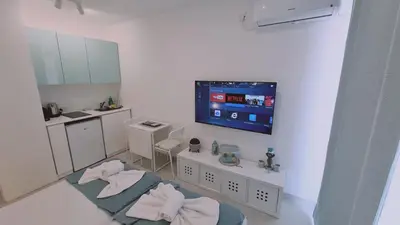 a kitchen with a tv on the wall at STAY Napa Oasis Studio in Ayia Napa
