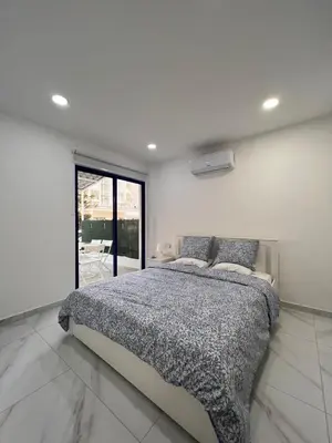 a bedroom with a bed and a large window at Mandy's apartment in Larnaka