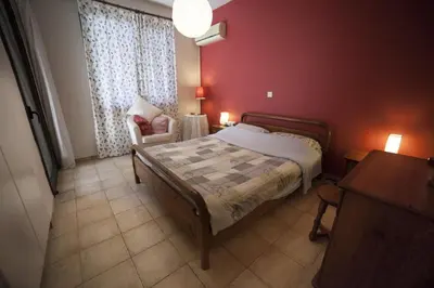 a bedroom with a bed and a table and a chair at El Marco Villa in Pissouri