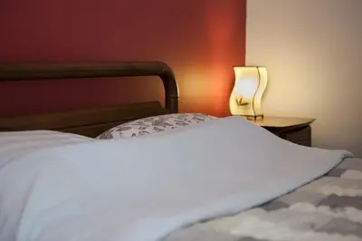 a bedroom with a bed and a table with a lamp at El Marco Villa in Pissouri