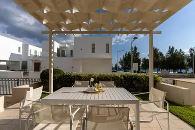 a white table and chairs on a patio at Niki Seaview Villa DPS27 in Protaras
