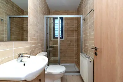 a bathroom with a toilet and a sink and a shower at Niki Seaview Villa DPS27 in Protaras