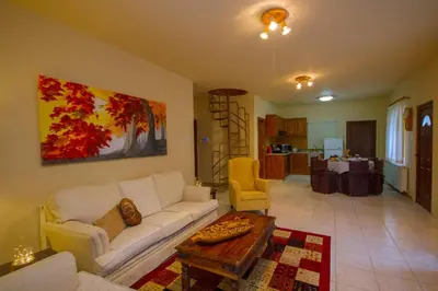 a living room with a white couch and a table at VILLa PERSEPHONE in Platres