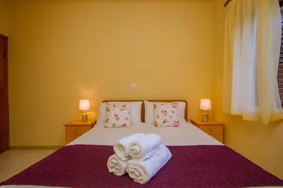 a bedroom with a bed with towels on it at VILLa PERSEPHONE in Platres