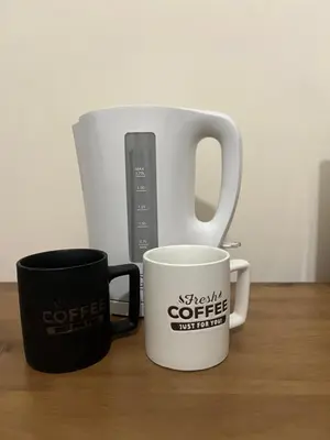 two coffee mugs are sitting on a table at Enjoy a cozy room in the heart of the capital in Nicosia