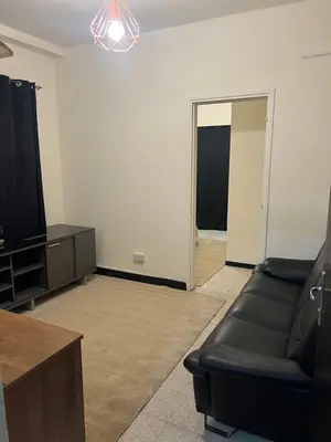 a living room with a couch and a television at Enjoy a cozy room in the heart of the capital in Nicosia