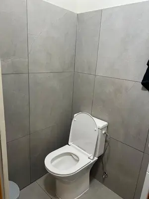 a bathroom with a white toilet in a room at Enjoy a cozy room in the heart of the capital in Nicosia