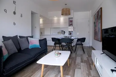 a living room with a couch and a table at Corina Suites & Apartments in Limassol