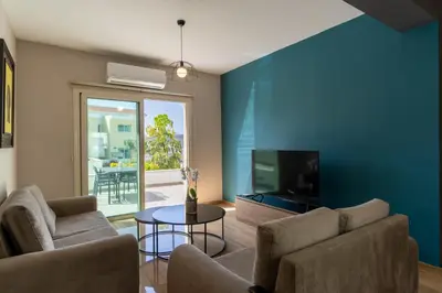 a living room with a couch and a tv at Modern Townhouse with pool ten minutes Limassol Center in Limassol