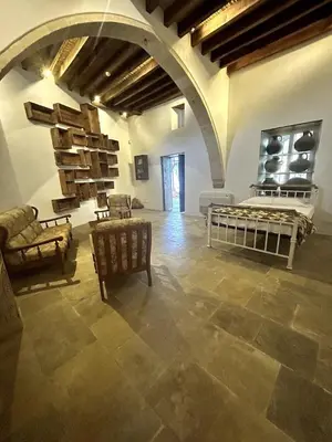 a large room with chairs and furniture in a building at Archontiko Papadopoulou in Mosphiloti