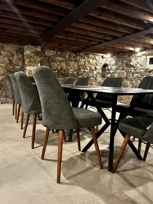 a row of chairs around a table in a room at Archontiko Papadopoulou in Mosphiloti