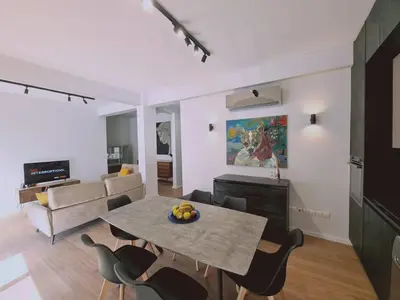 a living room with a table and chairs and a couch at Limassolian vibe house in Limassol