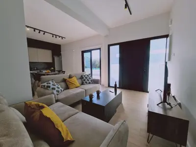 a living room with a couch and a table at Limassolian vibe house in Limassol