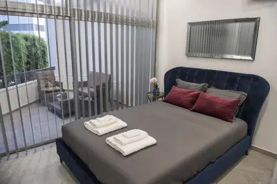 a bedroom with a blue bed with towels on it at STAY Urban Skin Suite in Nicosia