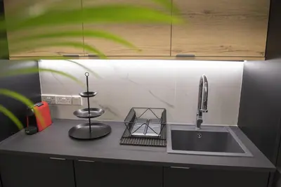 a kitchen counter top with a sink and a sink at STAY Urban Skin Suite in Nicosia