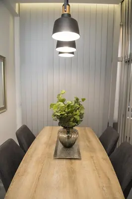 a dining room table with a potted plant on it at STAY Urban Skin Suite in Nicosia
