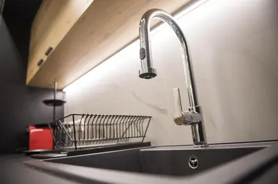 a kitchen sink with a faucet and a basket on it at STAY Urban Skin Suite in Nicosia