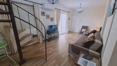 a living room with a couch and a stair case at STAY Sea and Salt Lake Panoramic View Apt in Larnaka