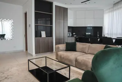 a living room with a couch and a table at 360 Luxury One Bedroom Suite in Nicosia