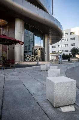 a building with two stone benches in front of it at 360 Luxury One Bedroom Suite in Nicosia