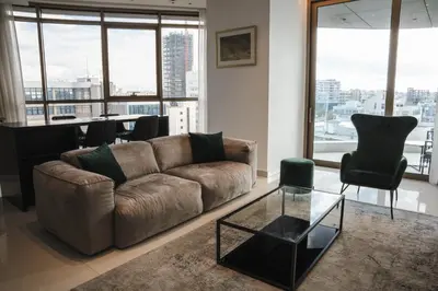 a living room with a couch and a table at 360 Luxury One Bedroom Suite in Nicosia