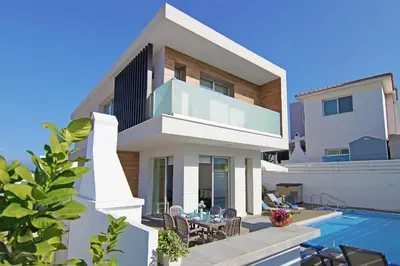 a villa with a swimming pool and a house at Thea Athena Villa - Walking to the Beach in Paralimni