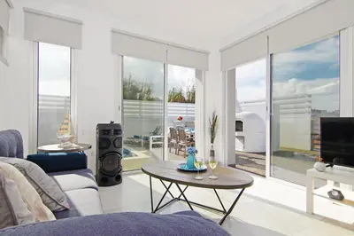 a living room with a couch and a table at Thea Athena Villa - Walking to the Beach in Paralimni