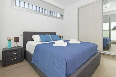 a bedroom with a blue bed with towels on it at Thea Athena Villa - Walking to the Beach in Paralimni
