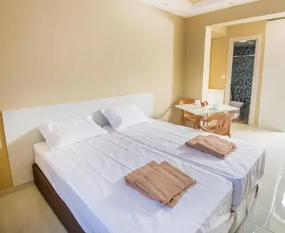 a bedroom with a bed with two towels on it at Marisa Napa Suites Ayia Napa in Ayia Napa