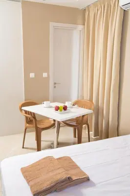 a white table with fruit on it in a room at Marisa Napa Suites Ayia Napa in Ayia Napa