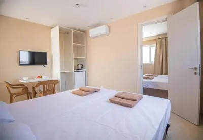 a bedroom with a bed with two towels on it at Marisa Napa Suites Ayia Napa in Ayia Napa