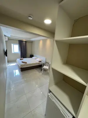 a bedroom with a bed and a room with a desk at Marisa Napa Suites Ayia Napa in Ayia Napa