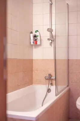 a bathroom with a bath tub with a shower at Stunning apartment with sea view in Larnaka