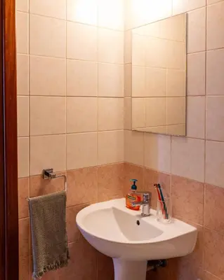 a bathroom with a white sink and a mirror at Stunning apartment with sea view in Larnaka