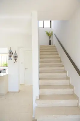 a staircase in a house with white walls and white floors at Cavo Greco Oasis in Protaras