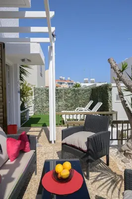 a patio with a table with a bowl of fruit on it at Cavo Greco Oasis in Protaras