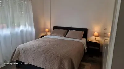a bedroom with a bed and two lamps on tables at Deana beach in Limassol