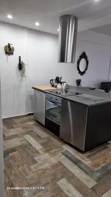 a kitchen with a sink and a stove top oven at Deana beach in Limassol