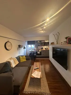 a living room with a couch and a table at Cozzi Deluxe Studio in Voroklini