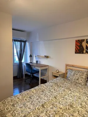 a bedroom with a bed and a desk and a table at Cozzi Deluxe Studio in Voroklini