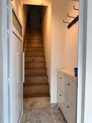 a staircase in a house with a door and a hallway at Cozzi Deluxe Studio in Voroklini