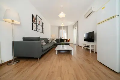 a living room with a couch and a table at 1 bedroom flat in city center in Nicosia