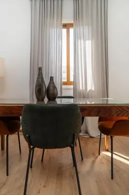 a dining room table with vases on top of it at 1 bedroom flat in city center in Nicosia