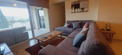a living room with a couch and a table at Pyla Gardens A104 in Pyla