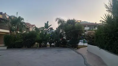 a parking lot with palm trees and houses at Pyla Gardens A104 in Pyla
