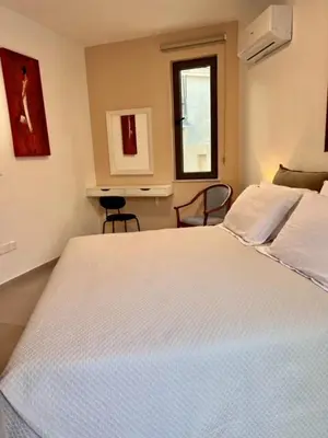 a bedroom with a large white bed in a room at 9 Muses Holiday apartments in Larnaka