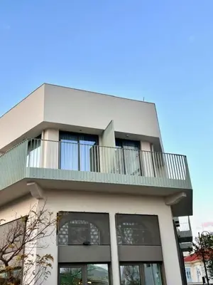 a building with a balcony on top of it at 9 Muses Holiday apartments in Larnaka
