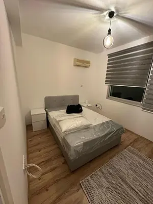 a bedroom with a bed and a ceiling fan at 5 minutes to the sea in Kyrenia new port in Meniko